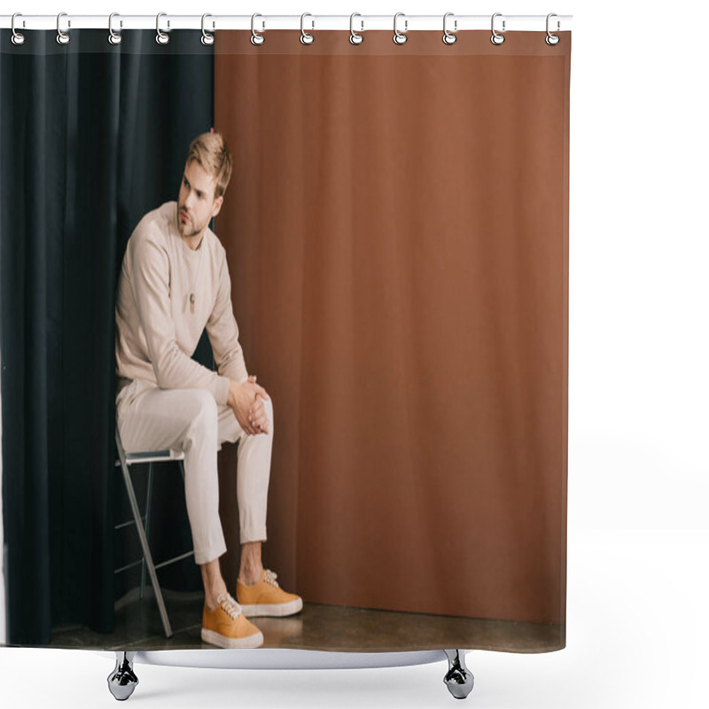 Personality  Man In Casual Outfit Sitting On Chair With Clenched Hands Near Curtain On Brown Shower Curtains