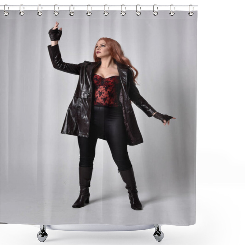 Personality  Full Length Portrait Of Girl With Long Red Hair Wearing Dark Leather Coat, Corset And Boots. Standing Pose Facing Front On With  Magical Hand Gestures Against A  Studio Background, Low Camera Angle. Shower Curtains