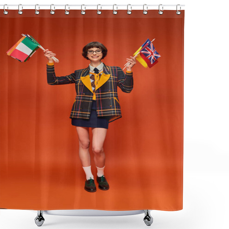 Personality  Happy Student Girl In Her Uniform And Glasses Holding Variety Of Flags On Orange Background Shower Curtains