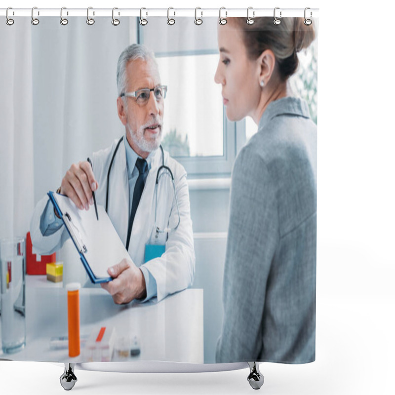 Personality  Smiling Male Doctor With Stethoscope Over Neck Pointing By Pencil At Clipboard To Female Patient At Table In Office  Shower Curtains