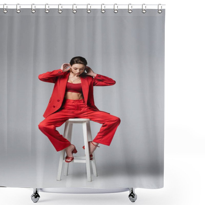 Personality  Full Length Of Brunette Woman In Red Suit And Shoes Sitting On White Chair On Dark Grey Shower Curtains