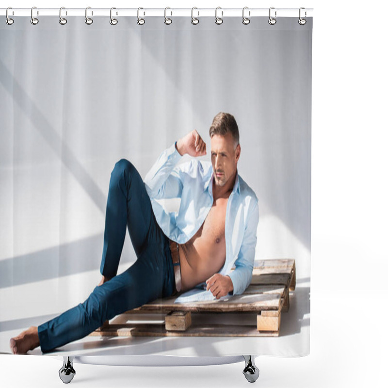 Personality  Sexy Man With Unbuttoned Shirt Lying On Wooden Pallet On White And Looking Away Shower Curtains