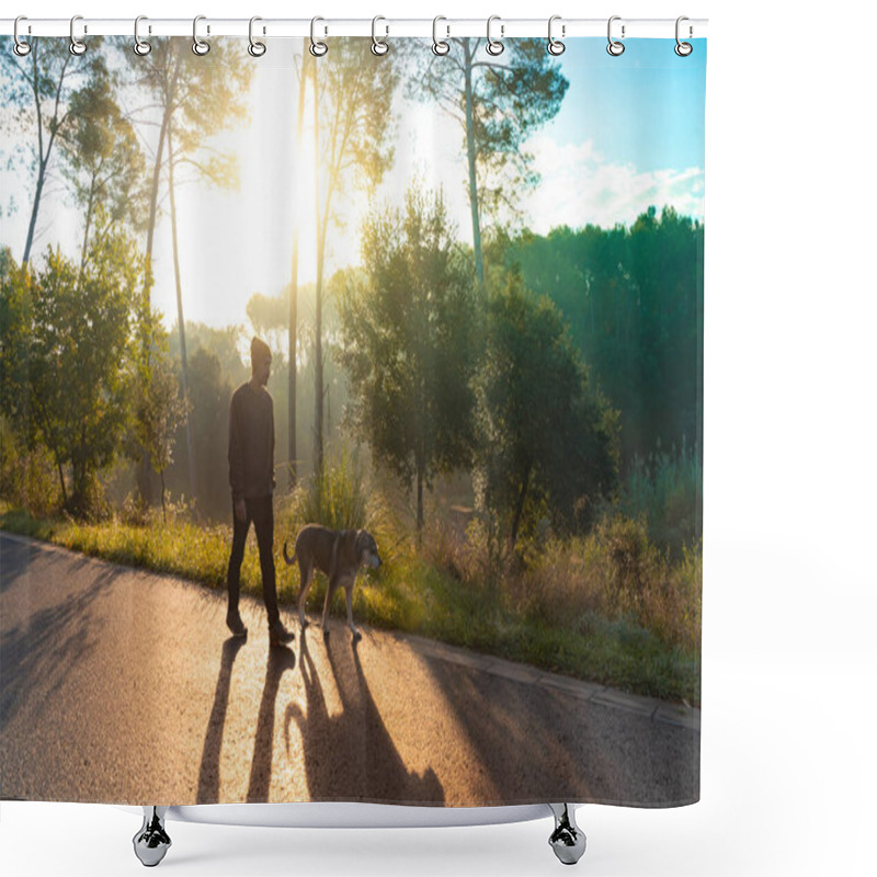 Personality  Young Handsome Man Walking His Dog In Nature With The Rays Of The Morning In Autumn. Friendship And Animal Love Concept. Sun, Warm Glow And Long Shadows. Shower Curtains