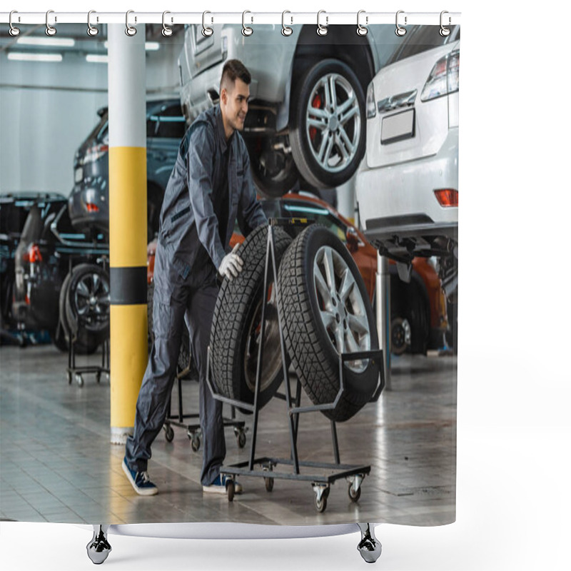 Personality  Handsome, Smiling Mechanic Taking New Tire From Stand Near Modern Cars In Workshop Shower Curtains