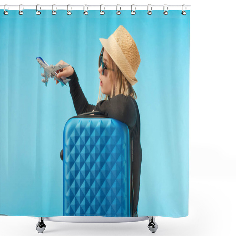 Personality  Blonde Girl In Sunglasses And Straw Hat Playing With Toy Airplane Near Blue Travel Bag Isolated On Blue Shower Curtains