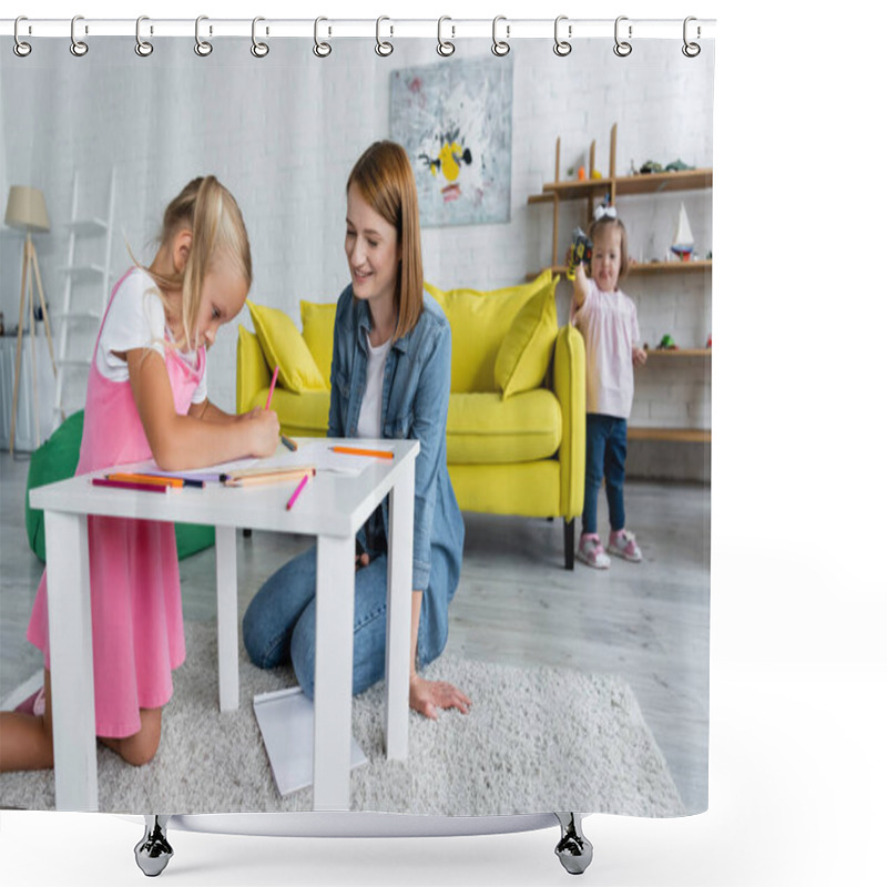 Personality  Happy Kindergarten Teacher Looking At Girl Drawing While Toddler Kid With Down Syndrome Standing On Blurred Background Shower Curtains