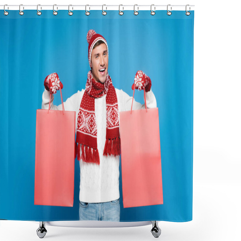 Personality  Happy Young Adult Man In Mittens Holding Red Paper Bags Isolated On Blue Shower Curtains