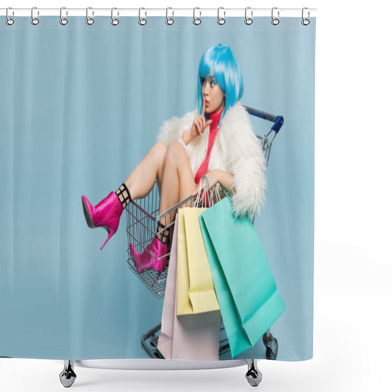 Personality  Asian Woman In Bright Wig And Furry Jacket Holding Shopping Bags In Cart And Showing Secret Gesture On Blue Background  Shower Curtains