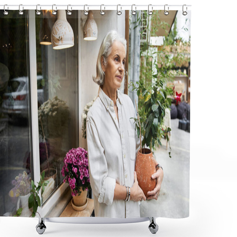 Personality  A Serene Mature Woman Stands Gracefully With A Potted Plant In A Cozy Cafe. Shower Curtains