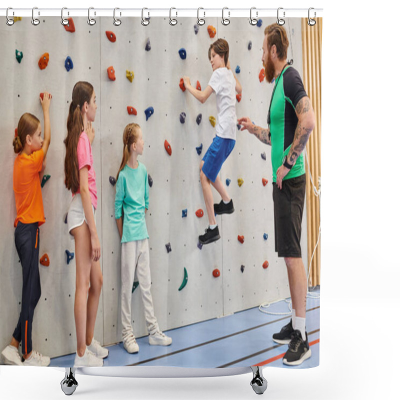 Personality  A Diverse Group Of Kids Are Energetically Climbing And Exploring A Wall While Being Supervised By Their Male Teacher In A Bright, Lively Classroom Setting. Shower Curtains