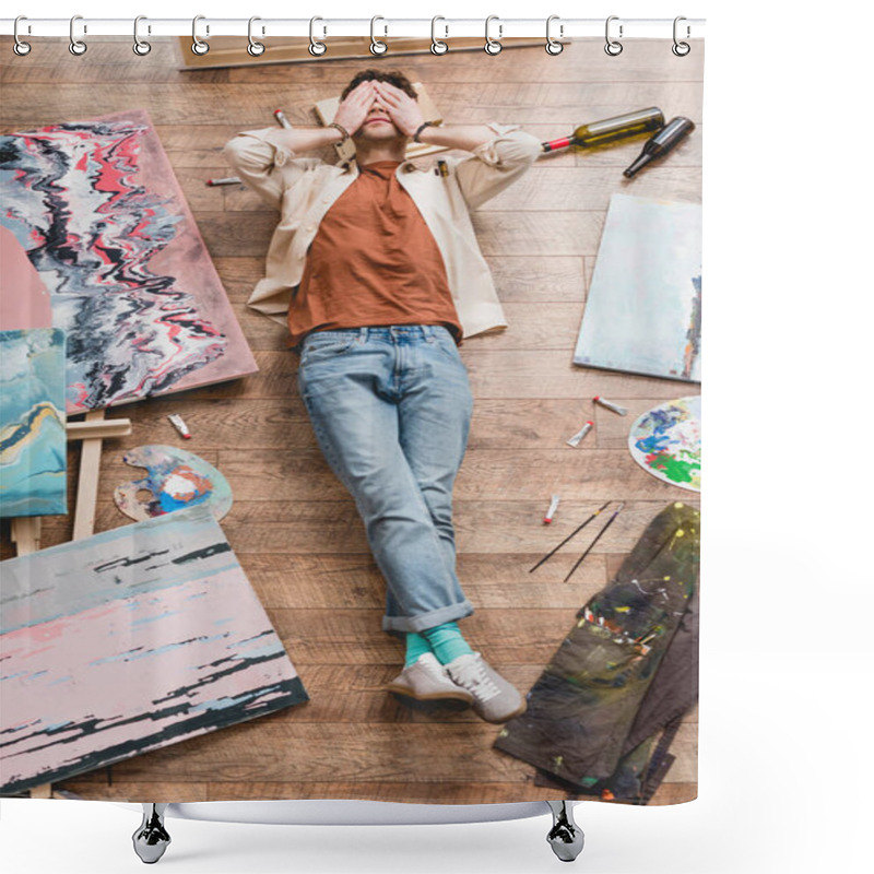 Personality  Overhead View Of Tired Artist Lying On Wooden Floor In Painting Studio And Holding Hands On Face Shower Curtains