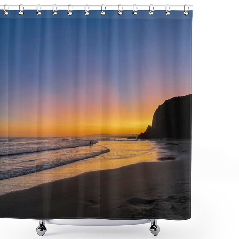 Personality  A Stunning Sunset Paints The Sky In Vivid Orange Tones, Reflecting On The Gentle Waves And Sandy Shore. Two Silhouetted Figures Walk Along The Water's Edge, With A Majestic Cliff Standing Tall In The Background. Shower Curtains