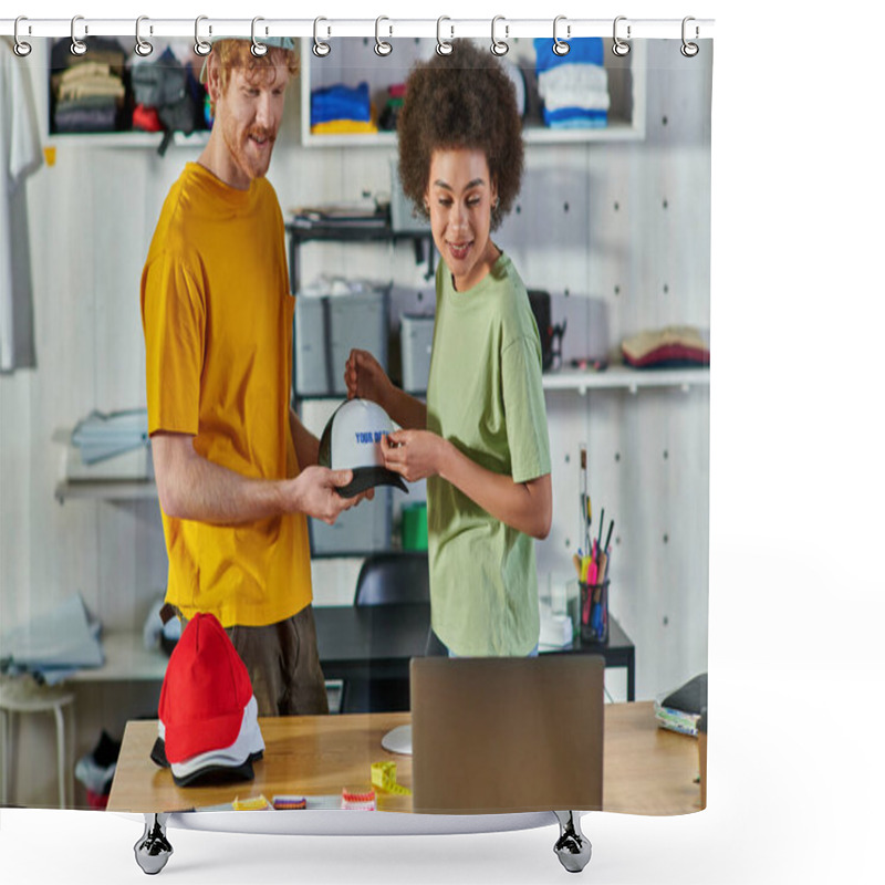 Personality  Smiling Young Multiethnic Designers Working With Printing Layer And Snapback While Looking At Laptop Near Cloth Samples In Print Studio At Background, Sustainable Business Model Concept Shower Curtains