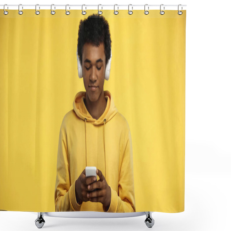 Personality  African American Teenage Boy In Wireless Headphones Using Smartphone Isolated On Yellow Shower Curtains