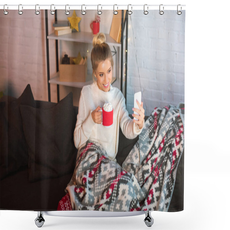 Personality  Young Happy Blonde Woman Covered In Blanket Sitting On Couch, Holding Cup Of Hot Cocoa With Marshmallows And Taking Selfie On Smartphone At Christmas Time  Shower Curtains