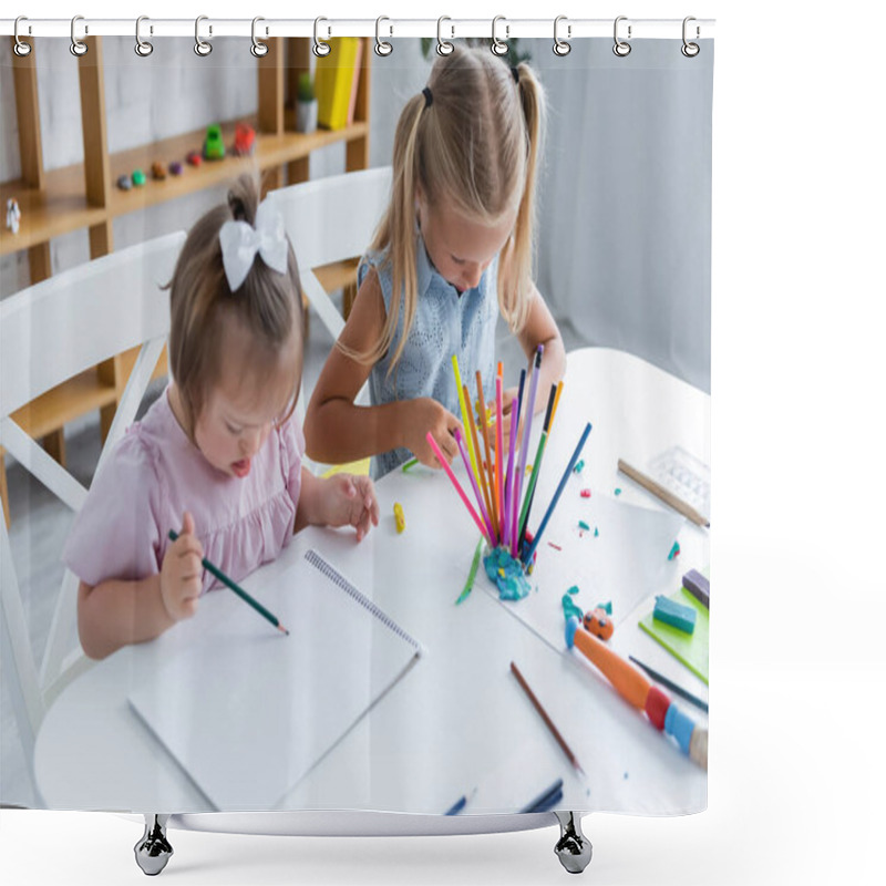 Personality  High Angle View Of Girl With Down Syndrome Drawing On Paper Near Child In Playroom  Shower Curtains