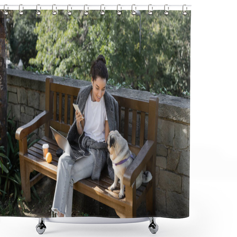 Personality  Smiling Freelancer In Earphones Holding Smartphone And Looking At Pug Dog While Sitting Near Laptop, Coffee To Go And Orange On Wooden Bench And Spending Time In Park In Barcelona, Spain  Shower Curtains