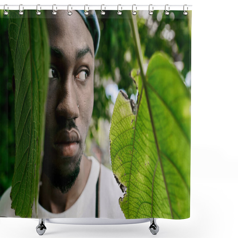 Personality  A Sophisticated African American Man Poses Stylishly Beside A Vivid Green Leaf In A Lush Garden. Shower Curtains