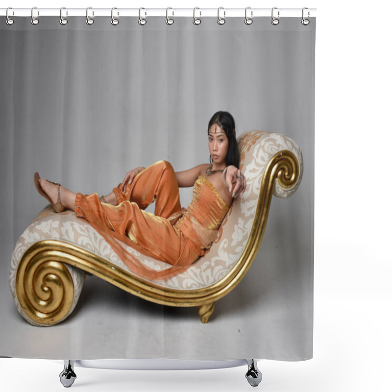 Personality  Full Length Portrait Of Pretty Young Asian Woman Wearing Golden Arabian Robes Like A Genie, Seated Pose On Lounge, Isolated On Studio Background. Shower Curtains