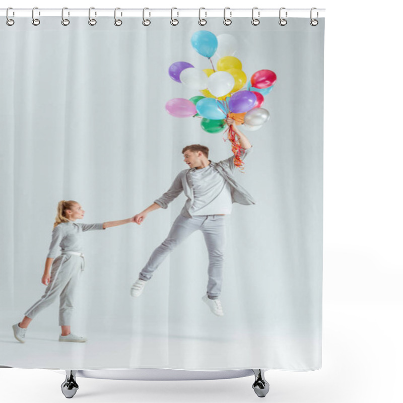 Personality  Beautiful Woman Holding Hand Of Man Jumping In Air With Bundle Of Colorful Balloons On Grey Background Shower Curtains