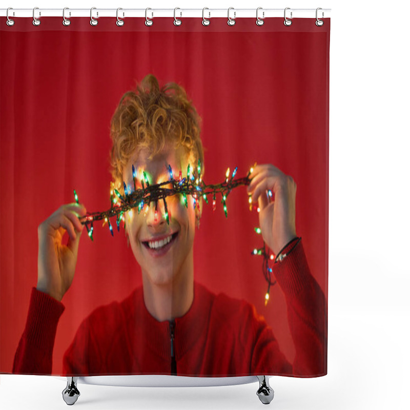 Personality  In A Vibrant Red Setting, A Young Man Beams With Joy, Playfully Holding Colorful Christmas Lights Across His Eyes. Shower Curtains