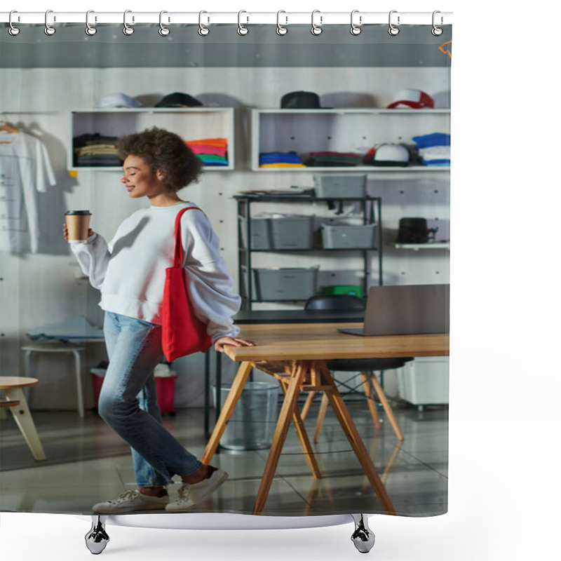 Personality  Side View Of Young And Positive African American Craftswoman With Shoulder Bag Holding Coffee To Go And Standing Near Laptop On Table In Print Studio, Enthusiastic Business Owner Working In Workshop Shower Curtains