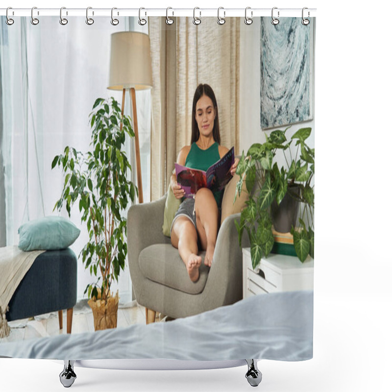 Personality  A Young Woman With Short Stature Enjoys A Peaceful Moment At Home, Lounging In A Comfy Chair While Reading A Captivating Book. Shower Curtains