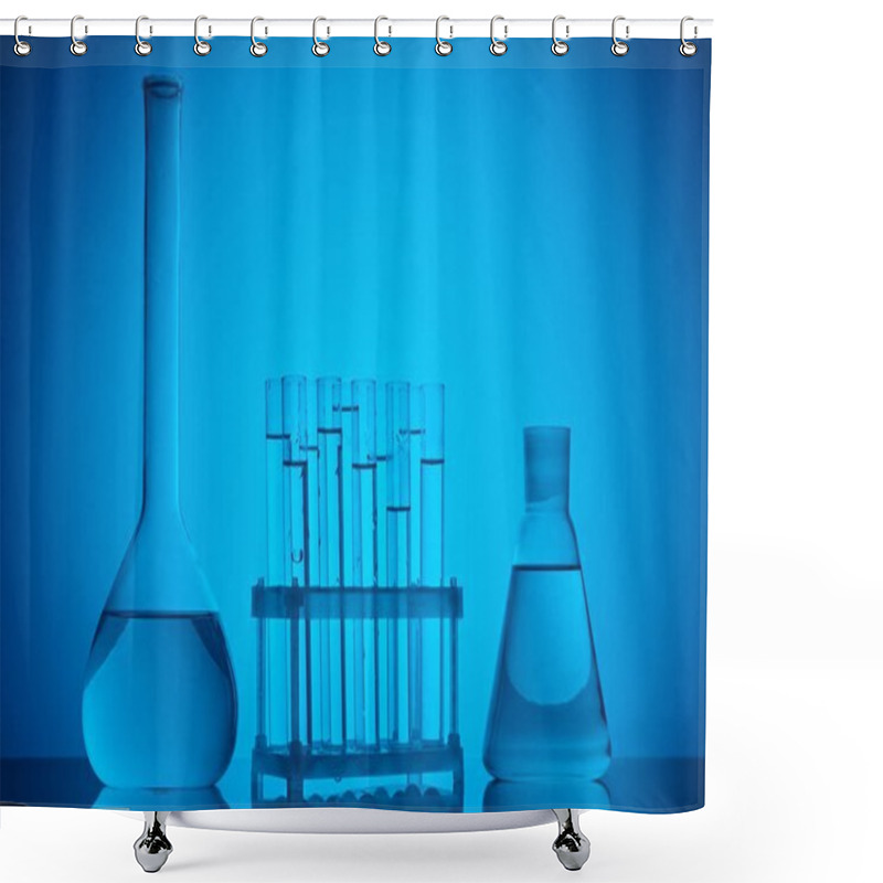 Personality  Glass Tubes On Stand And Glass Flasks With Liquid On Table On Blue Shower Curtains