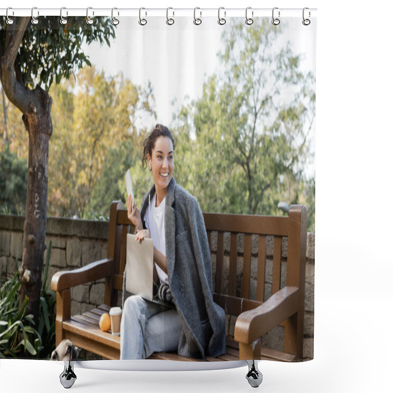 Personality  Smiling Brunette Freelancer In Warm Jacket Using Earphones And Devices While Spending Time Near Pug Dog, Coffee To Go And Orange On Wooden Bench In Park In Barcelona, Spain  Shower Curtains