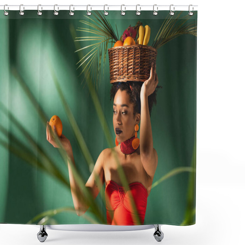 Personality  Young African American Woman Holding Orange And Basket With Exotic Fruits On Head Behind Blurred Palm Leaves On Green Shower Curtains