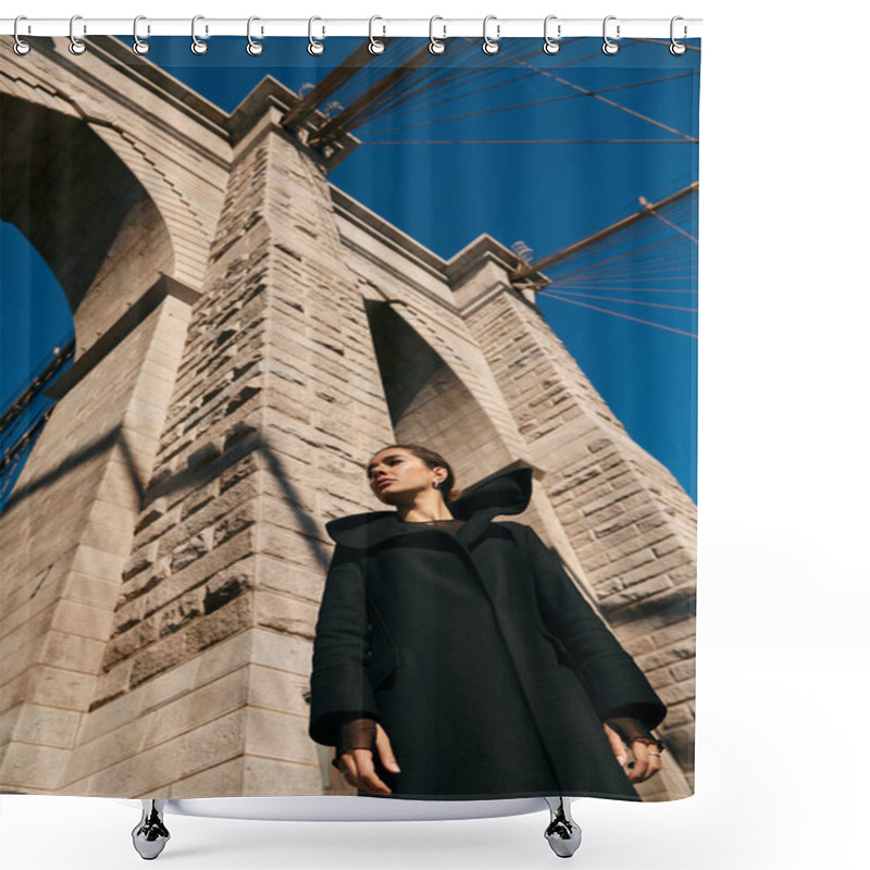 Personality  A Young Woman In A Black Coat Stands Beneath The Imposing Arch Of A New York City Bridge. Shower Curtains