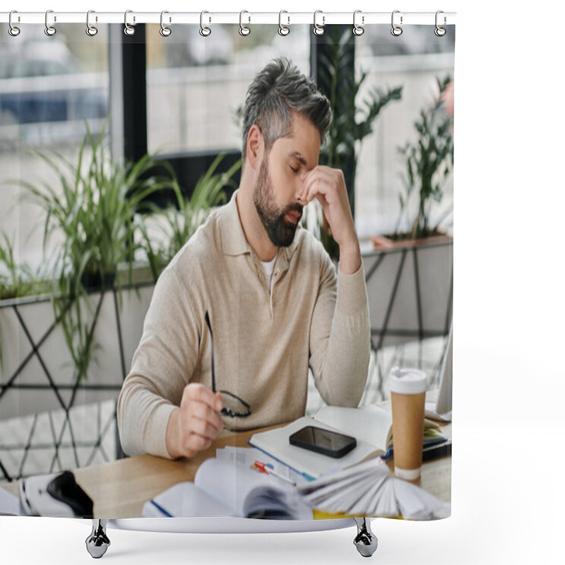 Personality  A Bearded Businessman In A Modern Office, Seemingly Lost In Thought As He Sits At His Desk Surrounded By Paperwork, A Smartphone, And A Cup Of Coffee. Shower Curtains