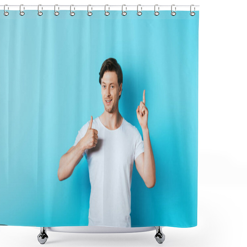 Personality  Young Man In White T-shirt Showing Thumb Up And Having Idea On Blue Background Shower Curtains