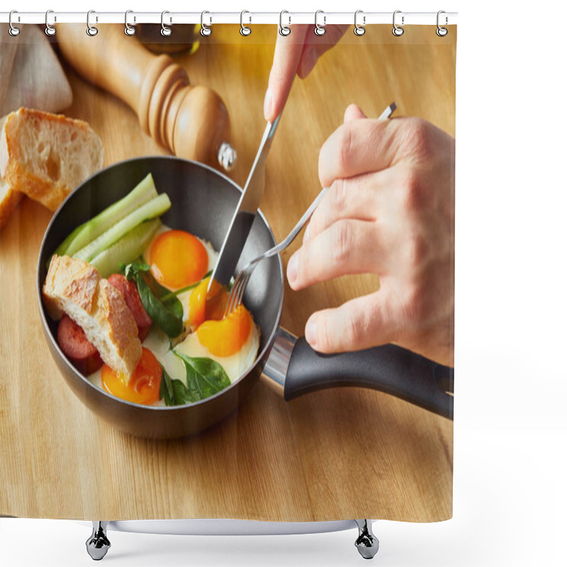 Personality  Cropped View Of Man Eating Fried Eggs With Fork And Knife At Wooden Table Shower Curtains