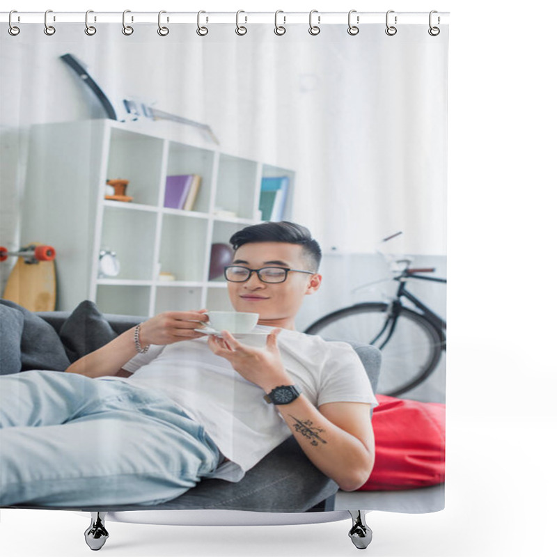 Personality  Happy Young Asian Man In Eyeglasses Lying On Couch And Holding Cup Of Coffee Shower Curtains