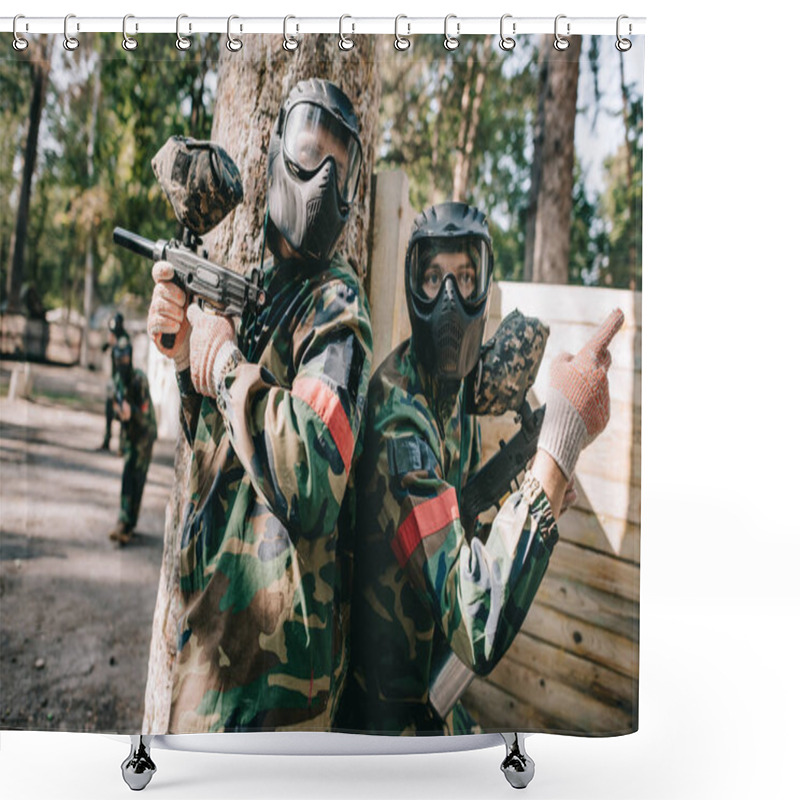 Personality  Male Paintball Player In Camouflage And Goggle Mask Pointing By Finger To His Teammate With Marker Gun Standing Near Tree Outdoors Shower Curtains