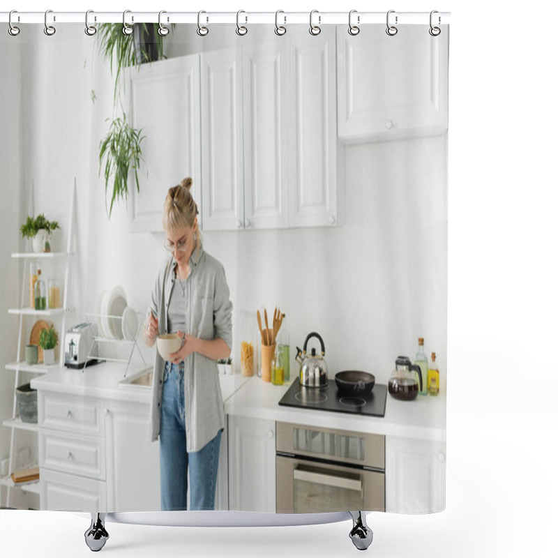 Personality  Young Woman With Bangs In Eyeglasses Holding Bowl With Cornflakes And Spoon While Standing In Casual Grey Clothes And Denim Jeans Next To Kitchen Appliances In Blurred White Kitchen At Home  Shower Curtains