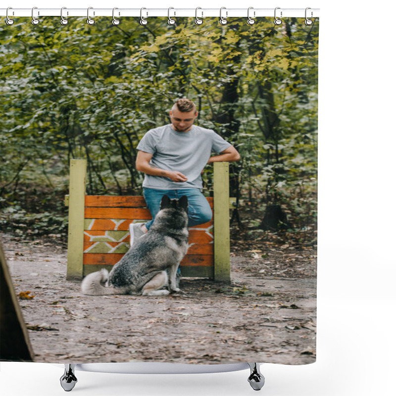 Personality  Young Man Training With Obedient Husky Dog On Jumping Obstacle  Shower Curtains