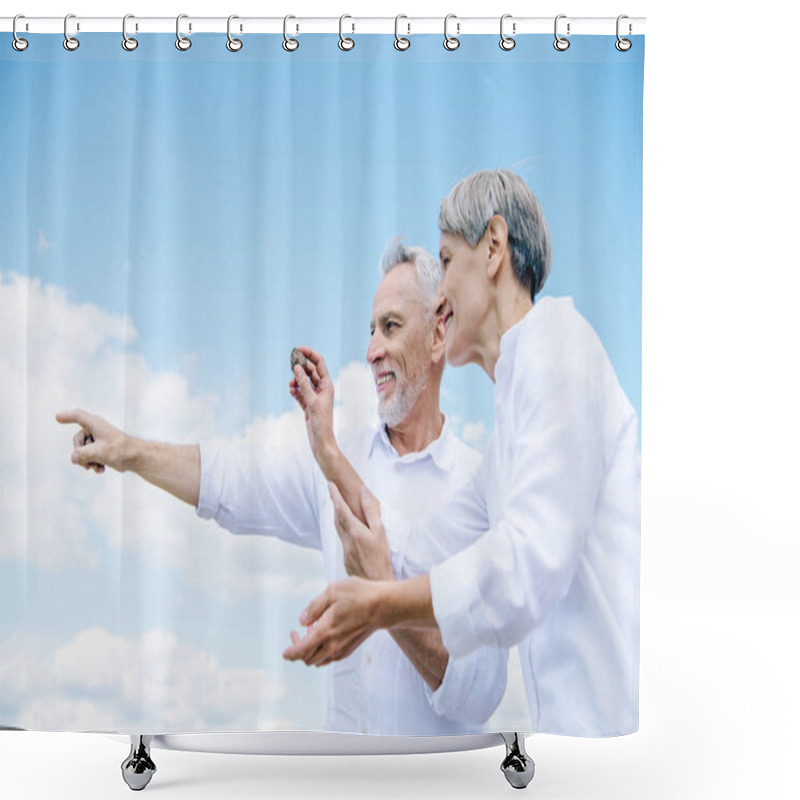 Personality  Happy Smiling Senior Couple Holding Stone And Pointing With Finger Under Blue Sky Shower Curtains