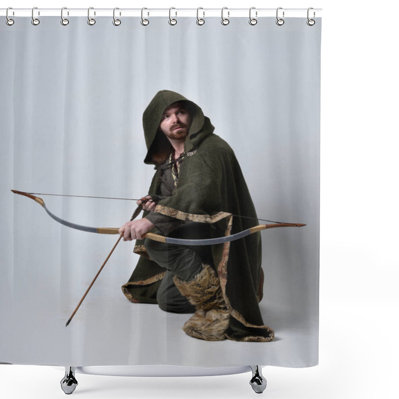 Personality  Full Length  Portrait Of  Young Handsome Man  Wearing  Medieval Celtic Adventurer Costume With Hooded Cloak, Holding  Archery Bow And Arrow, Isolated On Studio Background. Shower Curtains