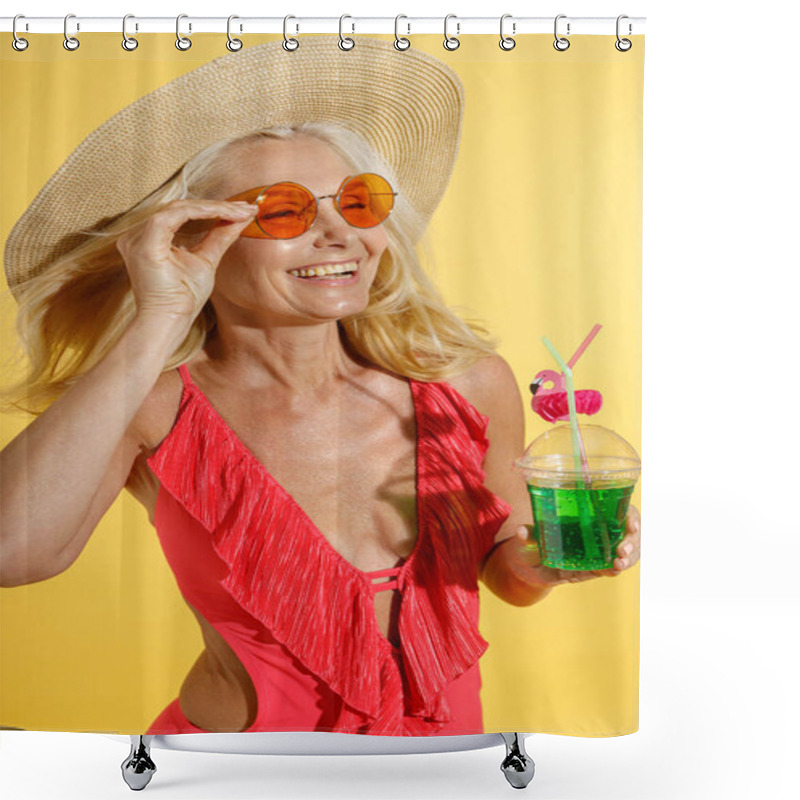 Personality  Lively Blonde Woman In Red Swimsuit And Straw Hat Smiling, Adjusting Sunglasses And Holding Cocktail Drink While Posing, Standing Isolated On Yellow Background Shower Curtains