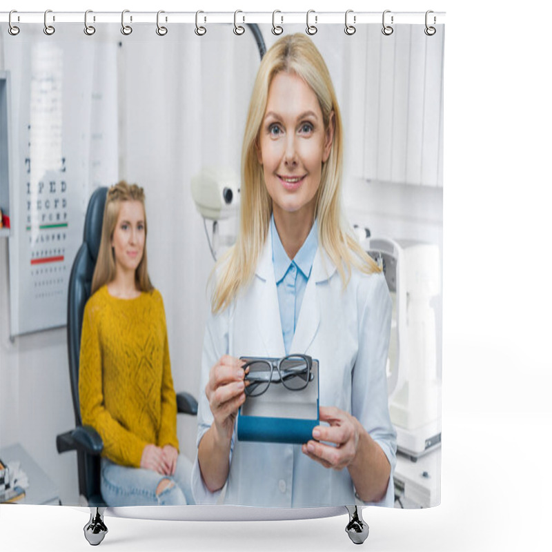 Personality  Optician In White Coat Holding Eyeglasses While Patient Sitting Behind Shower Curtains