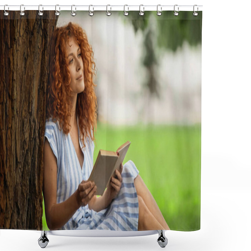 Personality  Pleased Redhead Woman In Striped Dress Holding Book And Sitting Under Tree Trunk  Shower Curtains