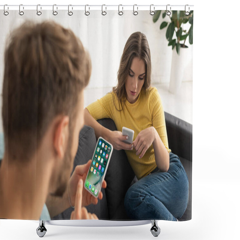 Personality  KYIV, UKRAINE - FEBRUARY 21, 2020: Selective Focus Of Man Using Smartphone With Iphone Screen Near Girlfriend Chatting On Sofa Shower Curtains