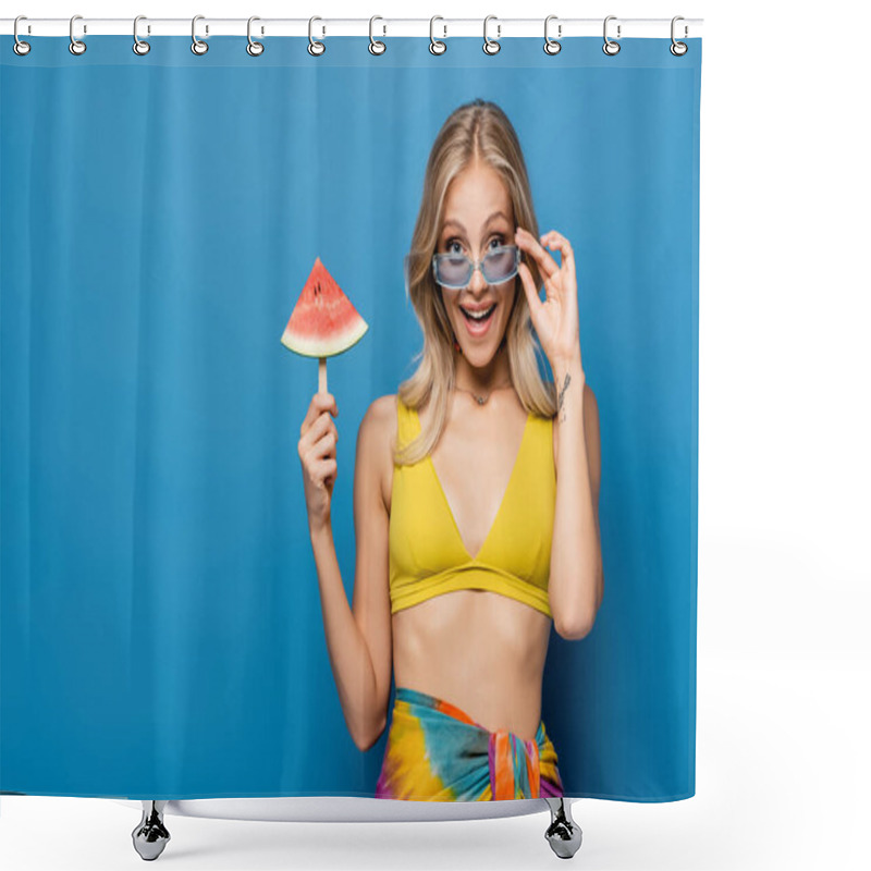 Personality  Cheerful Young Woman In Bikini Top Adjusting Sunglasses And Holding Popsicle Stick With Watermelon Isolated On Blue Shower Curtains