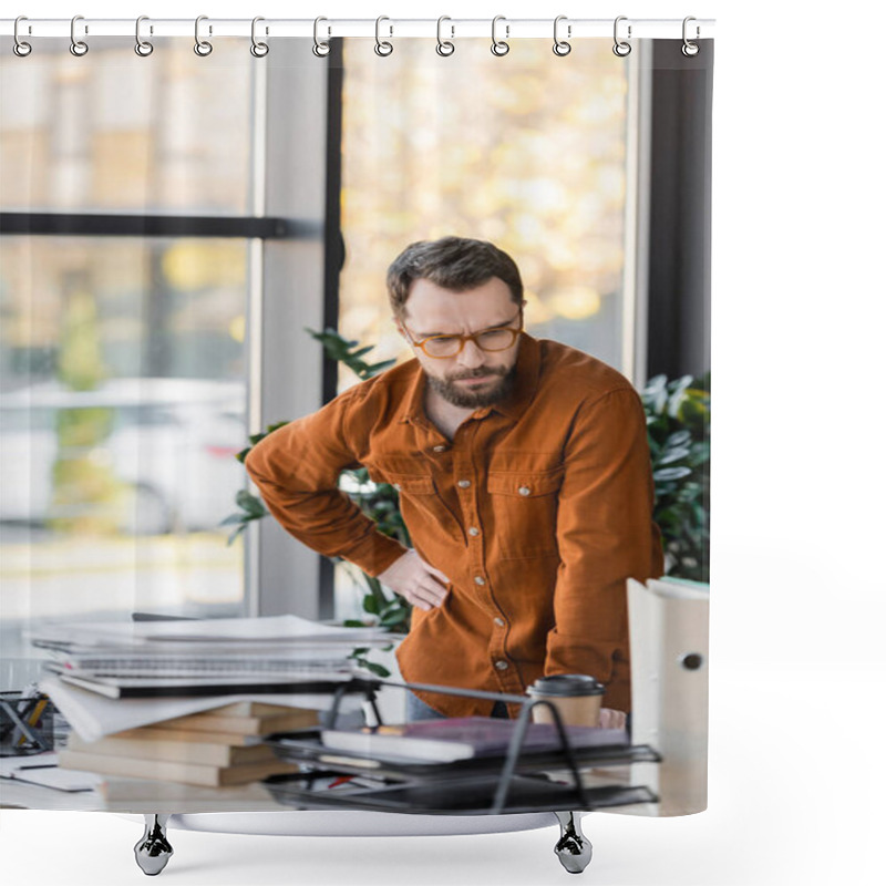 Personality  Pensive Bearded Businessman In Eyeglasses Standing With Hand On Hip And Looking At Plenty Of Books, Notebooks And Folders Near Paper Cup On Work Desk In Office Shower Curtains