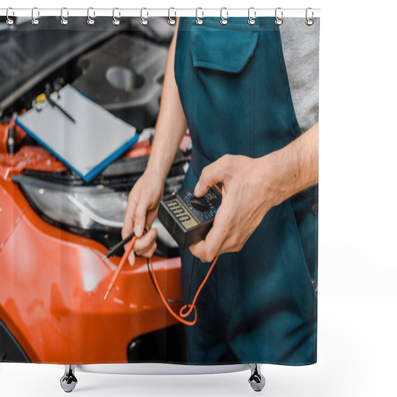 Personality  Cropped Shot Of Auto Mechanic Holding Multimeter Voltmeter For Car Battery Voltage Checking At Mechanic Shop Shower Curtains