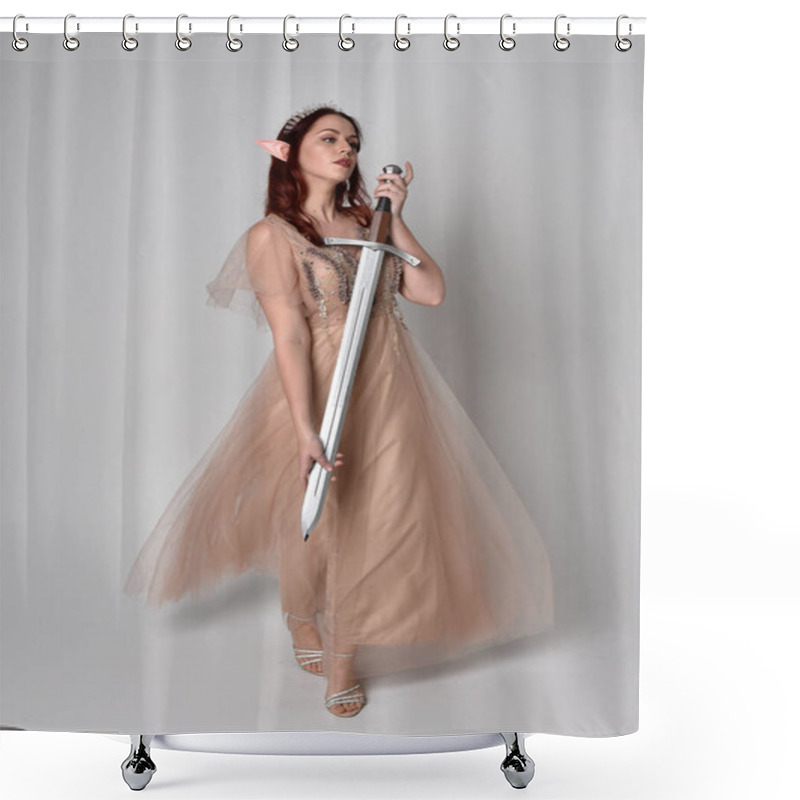 Personality  Full Length  Portrait Of Red Haired  Girl Wearing A Creamy Fantasy Gown And Crystal Crown, Like A Fairy Goddess Costume.  Standing Pose Holding A Sword Weapon  Isolated On Light Studio Background. Shower Curtains