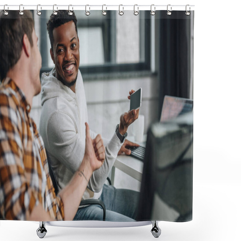 Personality  Selective Focus Of Smiling African American Programmer Holding Smartphone While Sitting Near Colleague Showing Thumb Up Shower Curtains