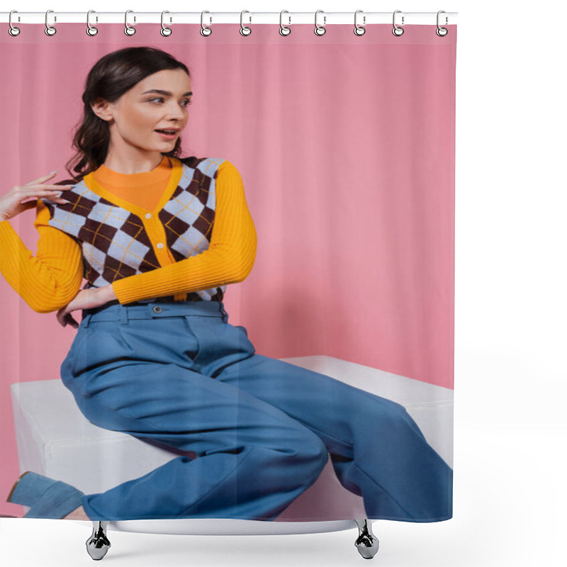 Personality  Surprised Woman In Trendy Cardigan And Blue Trousers Sitting On White Cube And Looking Away On Pink Background Shower Curtains